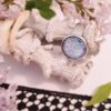Bague artisanale inox - cabochon fleurs bleu clair