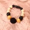 Bracelet d'allaitement et de portage fait main - silicone beige, noir et doré avec perle crochetée. Calino Crea