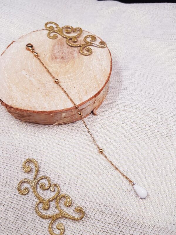 Bijou de dos artisanal - Chaîne dorée et goutte blanche. Calino Créa Bijou de dos artisanal - Chaîne dorée et goutte blanche. Calino Créa